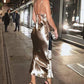 Long asymmetrical satin dress with gold bustier